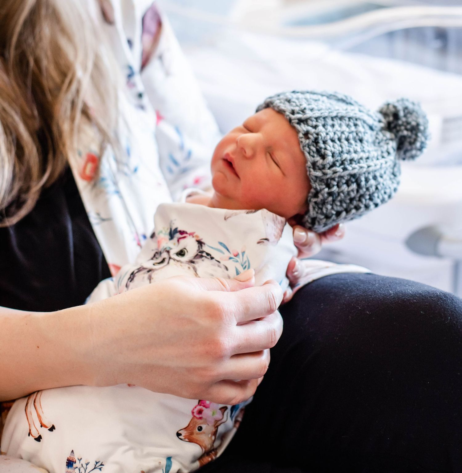 A series of intimate photos showing a newborn wearing a gray knit hat being held in a hospital setting.