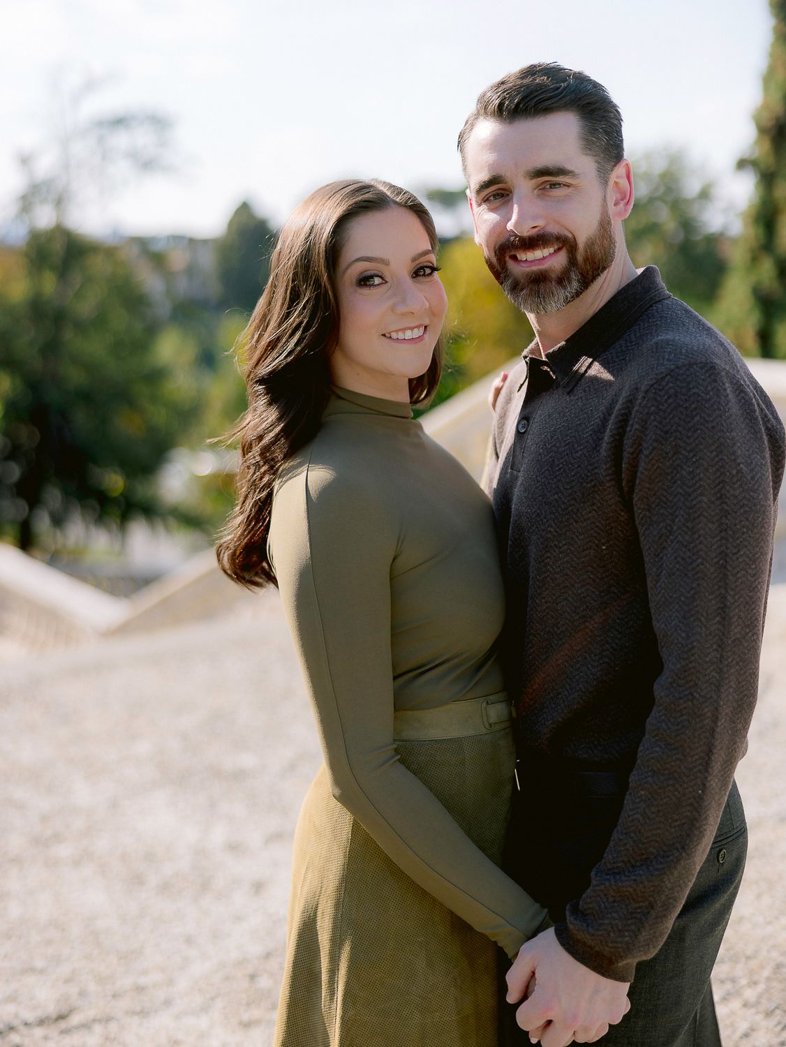 A couple shares tender moments together during an outdoor photo session in natural lighting.