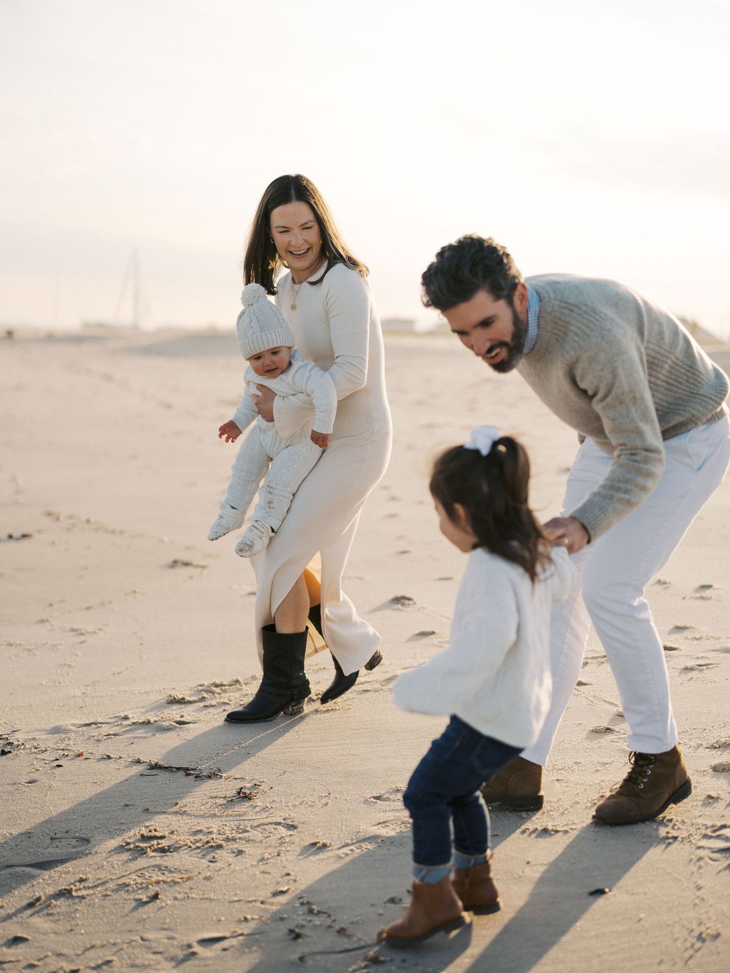 Family walking by the ocean during a fall photography session in Monmouth County, NJ