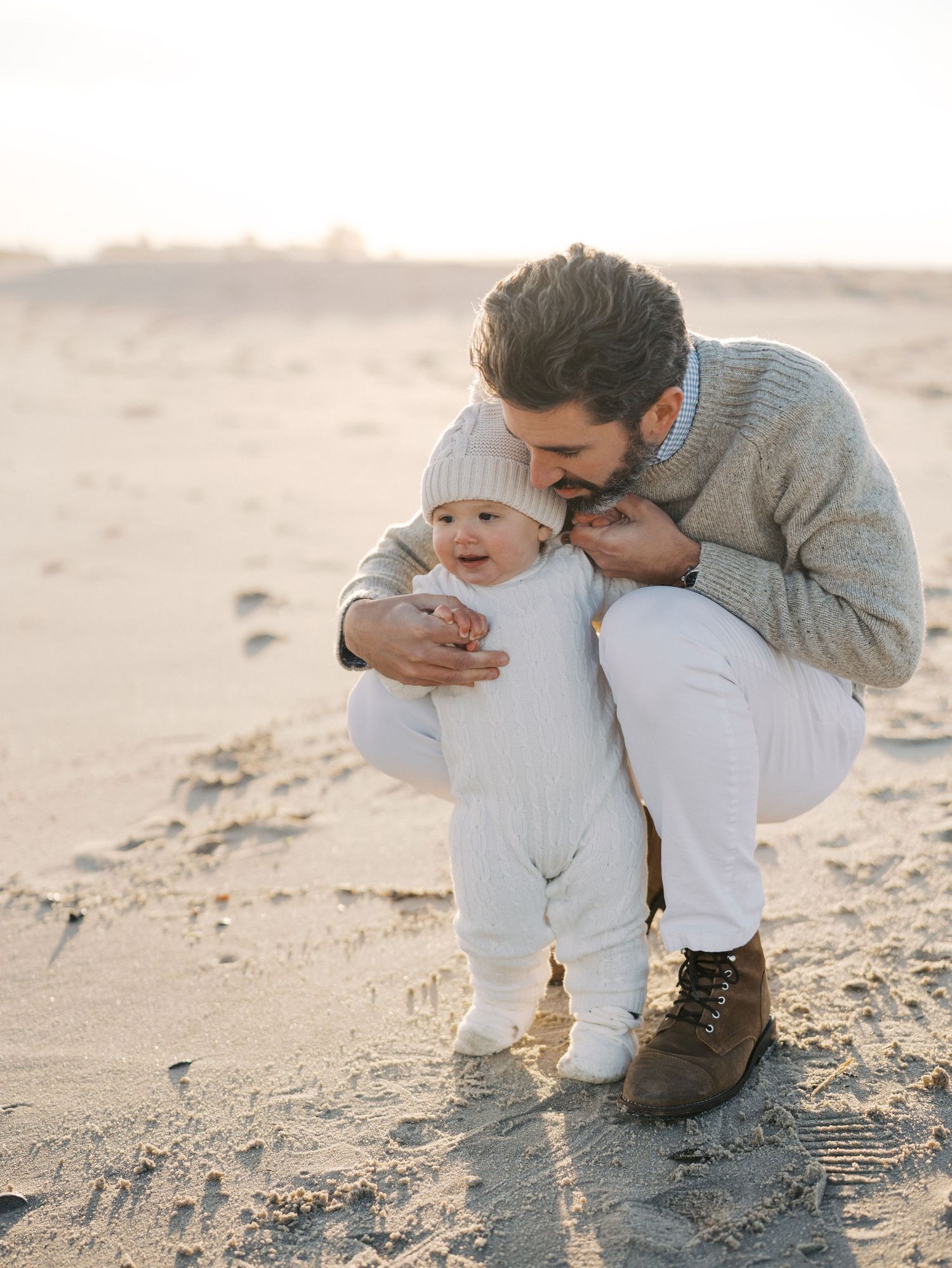 Father holding his son on the beach during a photography session in October in Monmouth County, NJ.