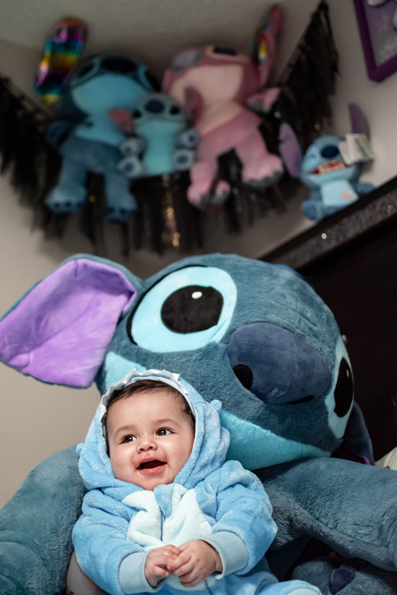 Smiling baby boy during his first Christmas holiday photo session in Puyallup, Washington with Stitch from Lilo and Stitch.