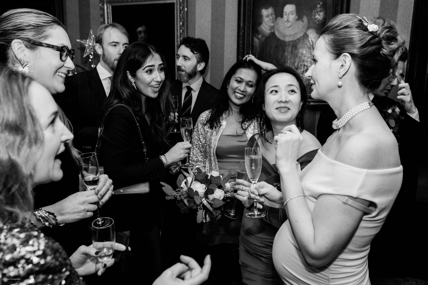 A collection of black and white photos showing joyful moments at a wedding reception with guests dancing and celebrating.