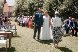 Wedding guests seated in white chairs for an outdoor garden ceremony. Hayne, Devon