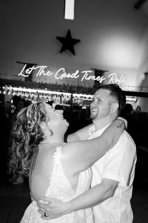 A couple dances together at their wedding reception in black and white. Hayne, Devon