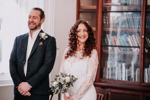 A wedding couple shares joyful moments together in a series of candid photos with white floral decorations.
