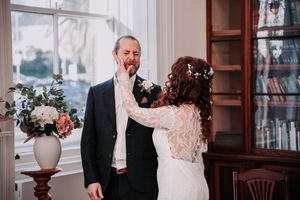 Elegant wedding couple shares a romantic dance together in a beautifully decorated indoor venue.