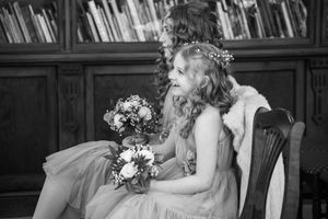 Series of black and white romantic wedding photos captured in natural window light.