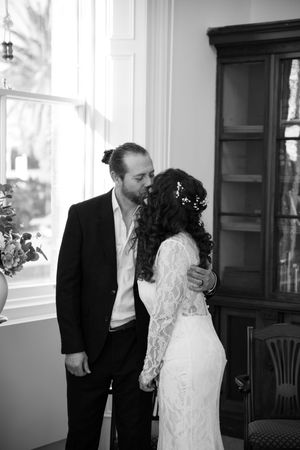 Black and white wedding photos showing intimate moments in an indoor setting.