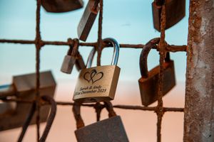 Row of rustic love locks against a blue sky background at sunset.