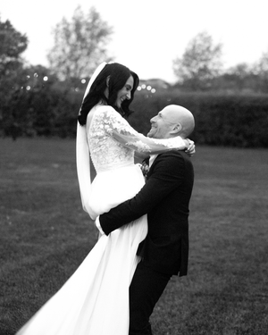Black and white wedding portraits capture romantic moments in an outdoor setting.