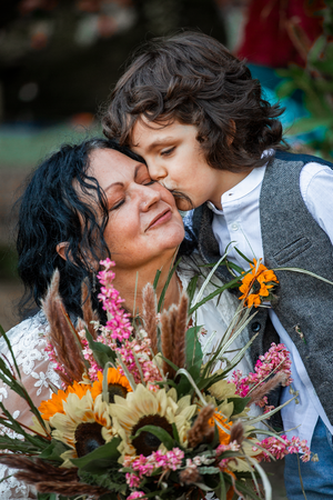 A romantic moment with a floral bouquet featuring pink flowers and bright sunflowers.