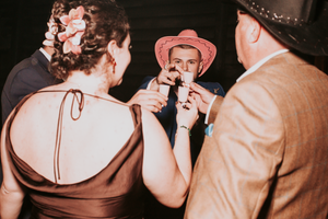 Wedding guests dancing and celebrating at a dimly lit reception venue.Direct Flash, Over Barn, Gloucester,