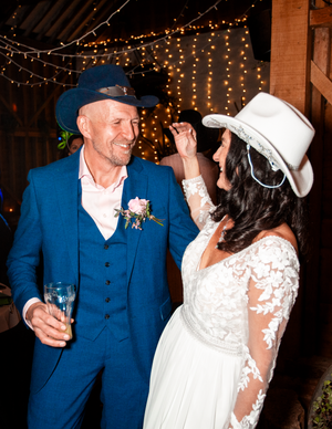 Couple dancing together under twinkling lights at their wedding reception.Direct Flash, Over Barn, Gloucester,