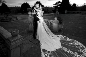 Dramatic black and white wedding photos with flowing bridal gown against outdoor backdrop. Direct Flash, Editorial.