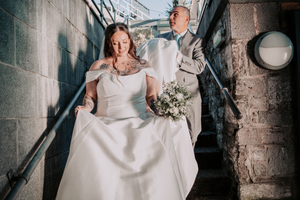 Bride in elegant white dress photographed in rustic stone interior.Pier One, Plymouth, Devon.
