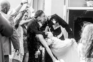 Black and white wedding celebration photos showing joyful moments indoors.Elfordleigh, Plymouth Devon