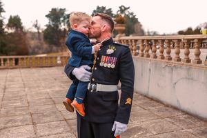 Wedding couple shares intimate moments on an elegant stone balcony.Elfordleigh, Plymouth Devon