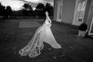 Black and white photos of a flowing wedding dress train on stone patio.Elfordleigh, Plymouth Devon