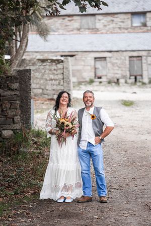 Rustic wedding photos featuring a beautiful bouquet against stone architecture. Porthcew Dairy, Porthleven, Cornwall