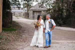 Casual wedding portraits taken along a rustic path with stone buildings. Porthcew Dairy, Porthleven, Cornwall