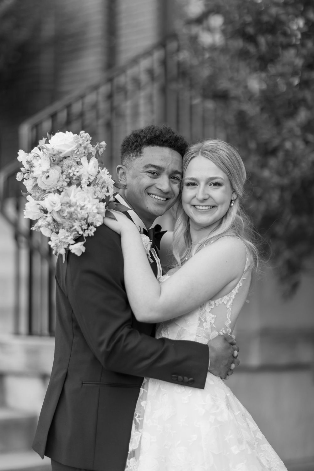 Black and white wedding photos showing a couple embracing and laughing together while holding a floral bouquet. NASHVILLE WEDDING PHOTOGRAPH