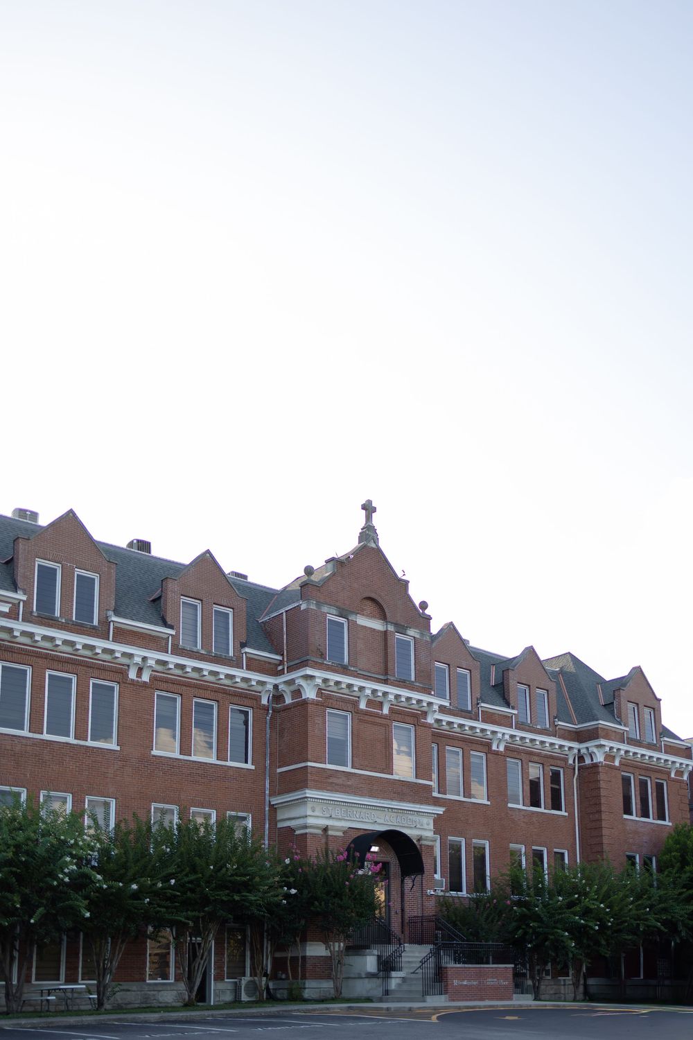 Historic red brick school building with ornate Victorian architecture and white trim details along the roofline.  NASHVILLE WEDDING PHOTO