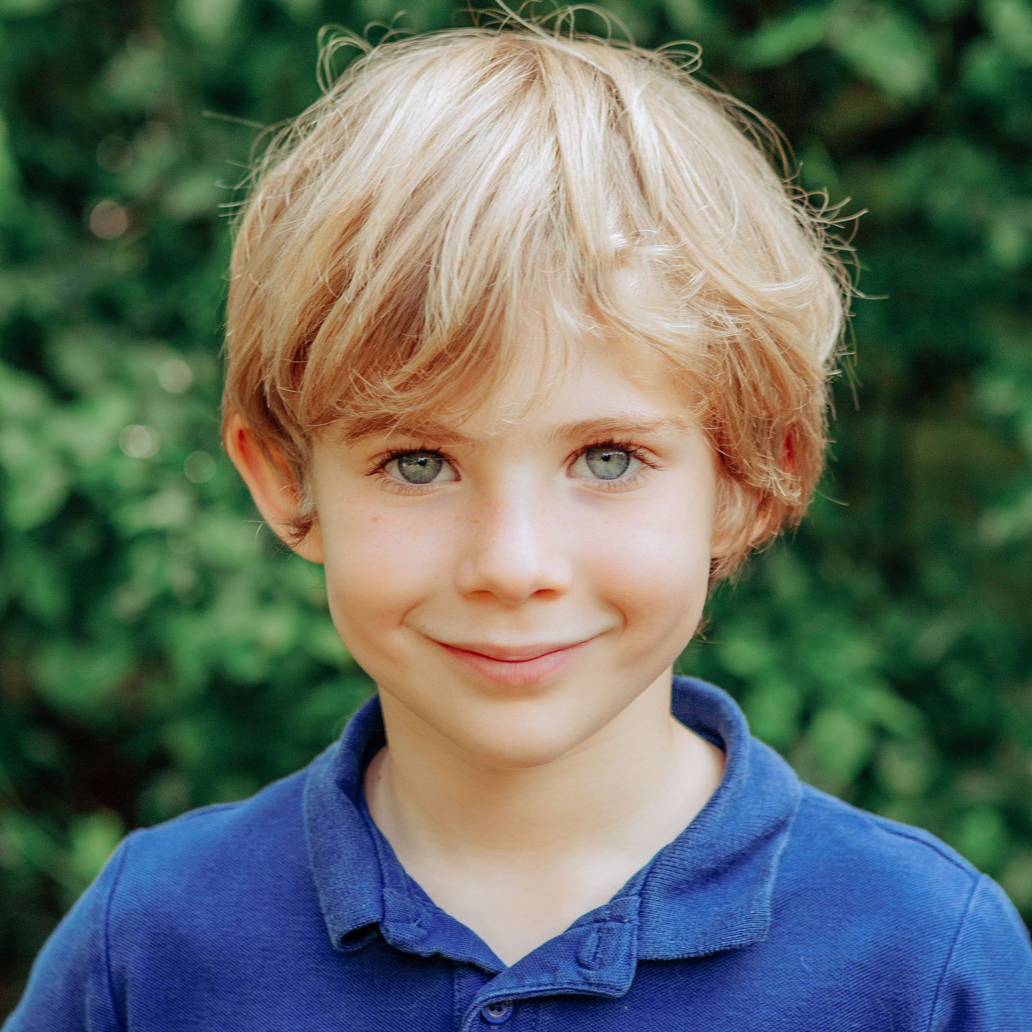 Close up school photo of a young boy smiling.