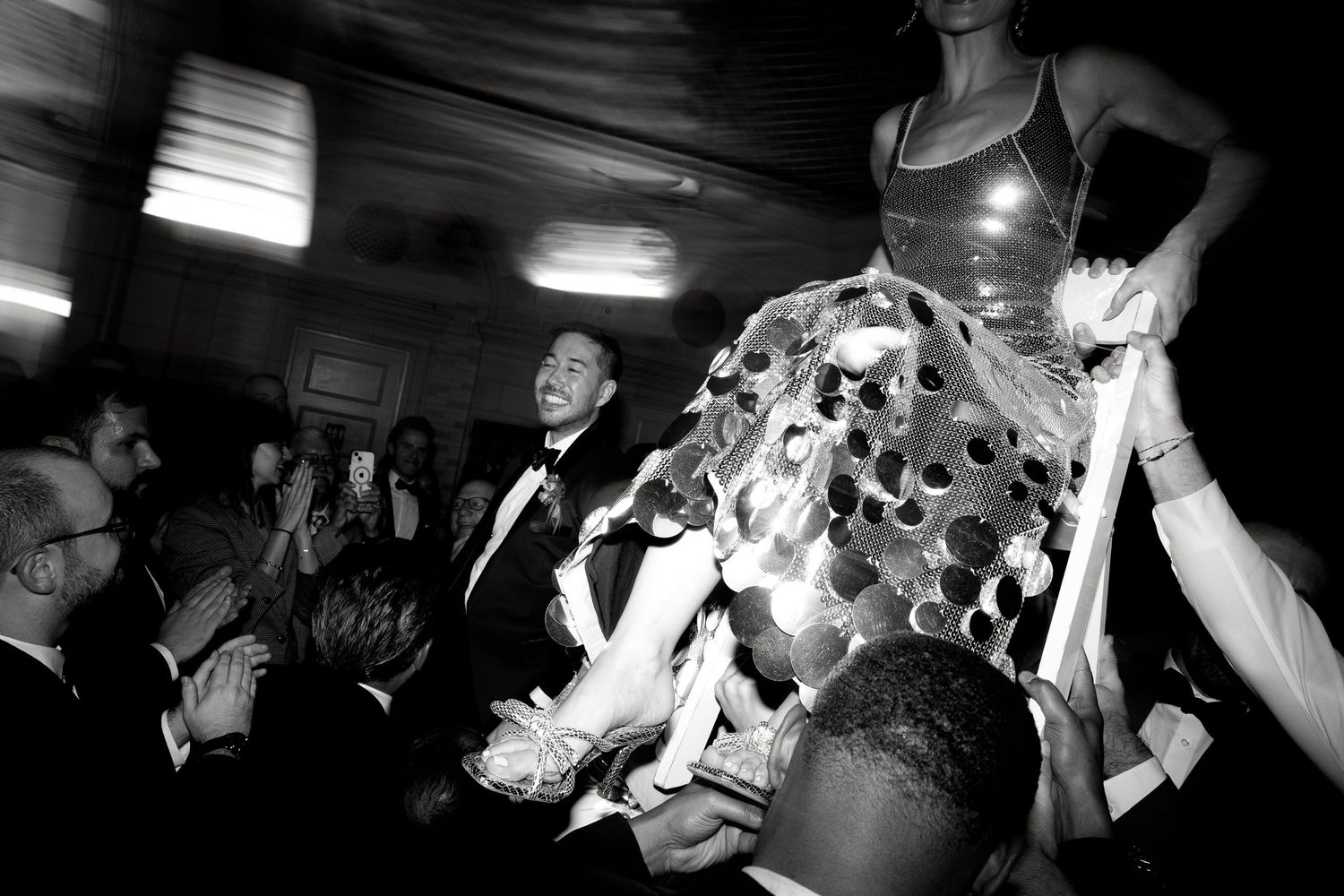 Black and white photos show people dancing and celebrating at what appears to be a lively party or reception.