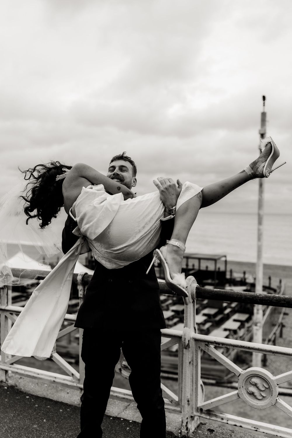 A sequence of black and white photos showing a couple dancing and dipping dramatically on a rooftop.