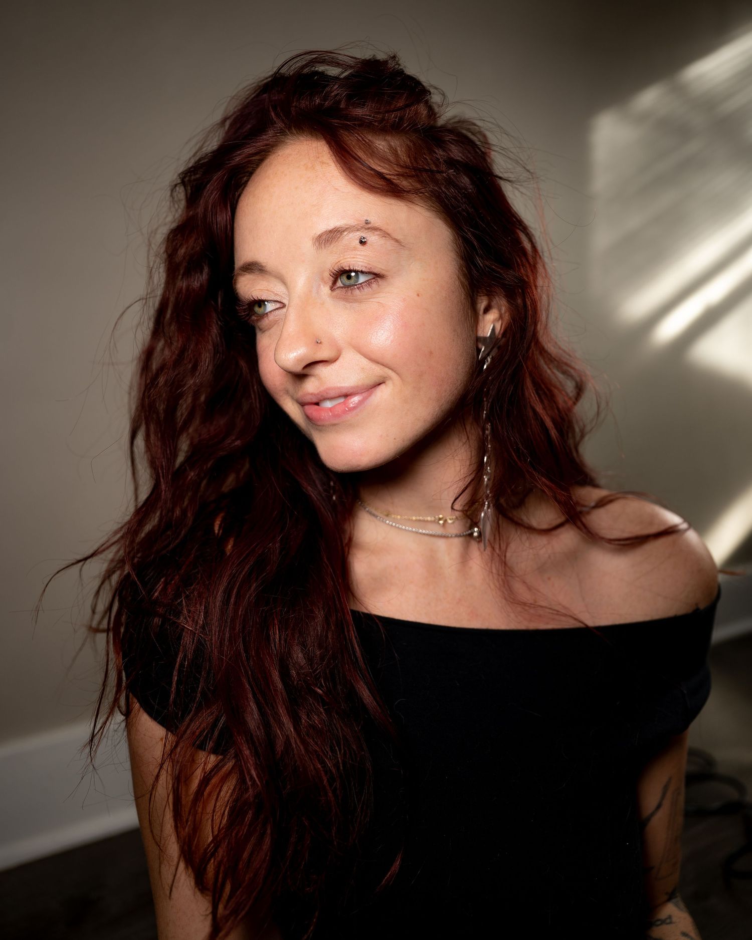 A series of artistic portraits showing a person with flowing dark hair in dramatic lighting against a neutral background.