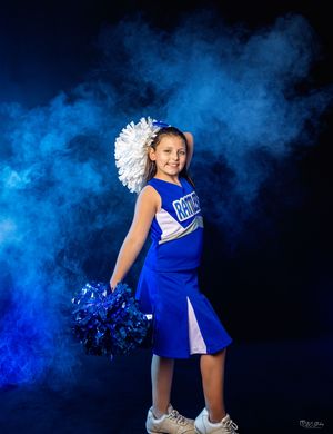 Cheerleader portraits with blue smoke effects and white pom poms.