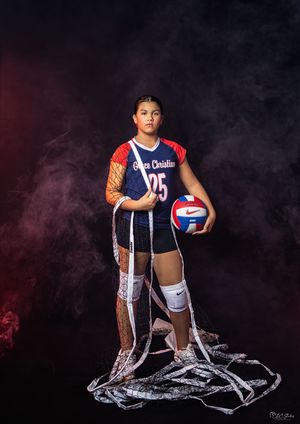 Dramatic volleyball player portrait with jersey number 25 against smoky background.