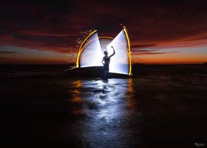 Stunning sequence of a boat sinking at night with dramatic lighting illuminating the dark waters.