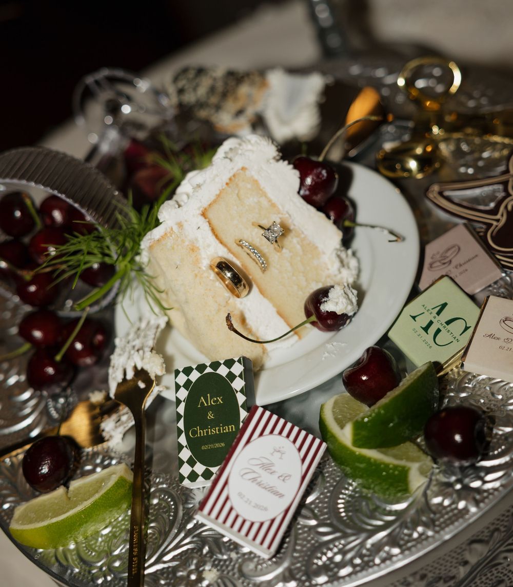 Elegant wedding table setting with fresh cherries, lime wedges, and decorative name cards on a silver platter.