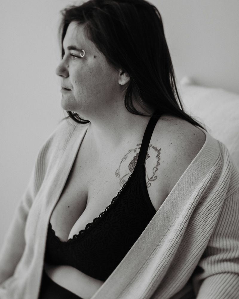 Black and white intimate portrait with lace trim and soft cardigan.