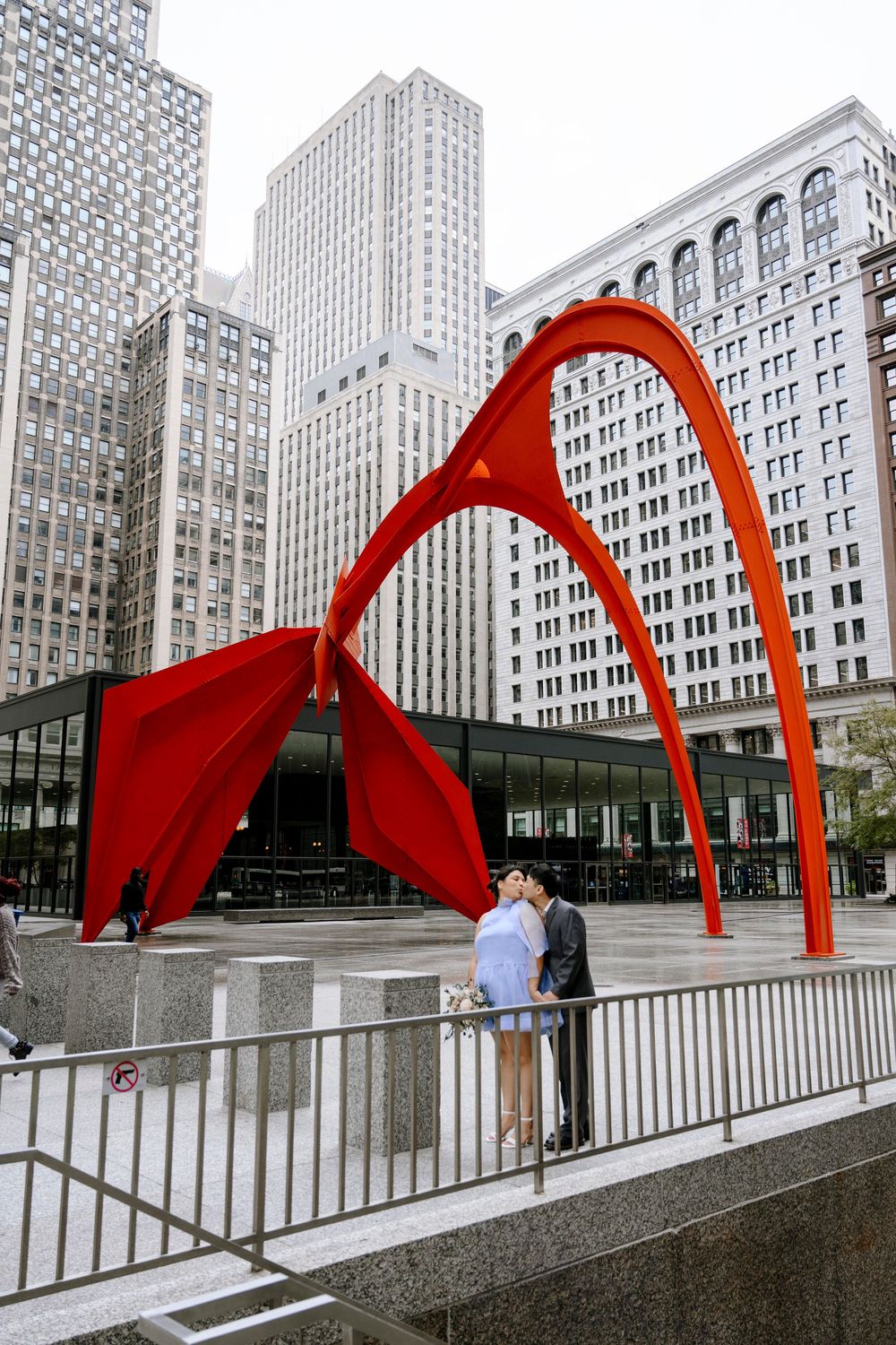 A red metal sculpture called Calder's Flamingo stands against Chicago's downtown skyscrapers.