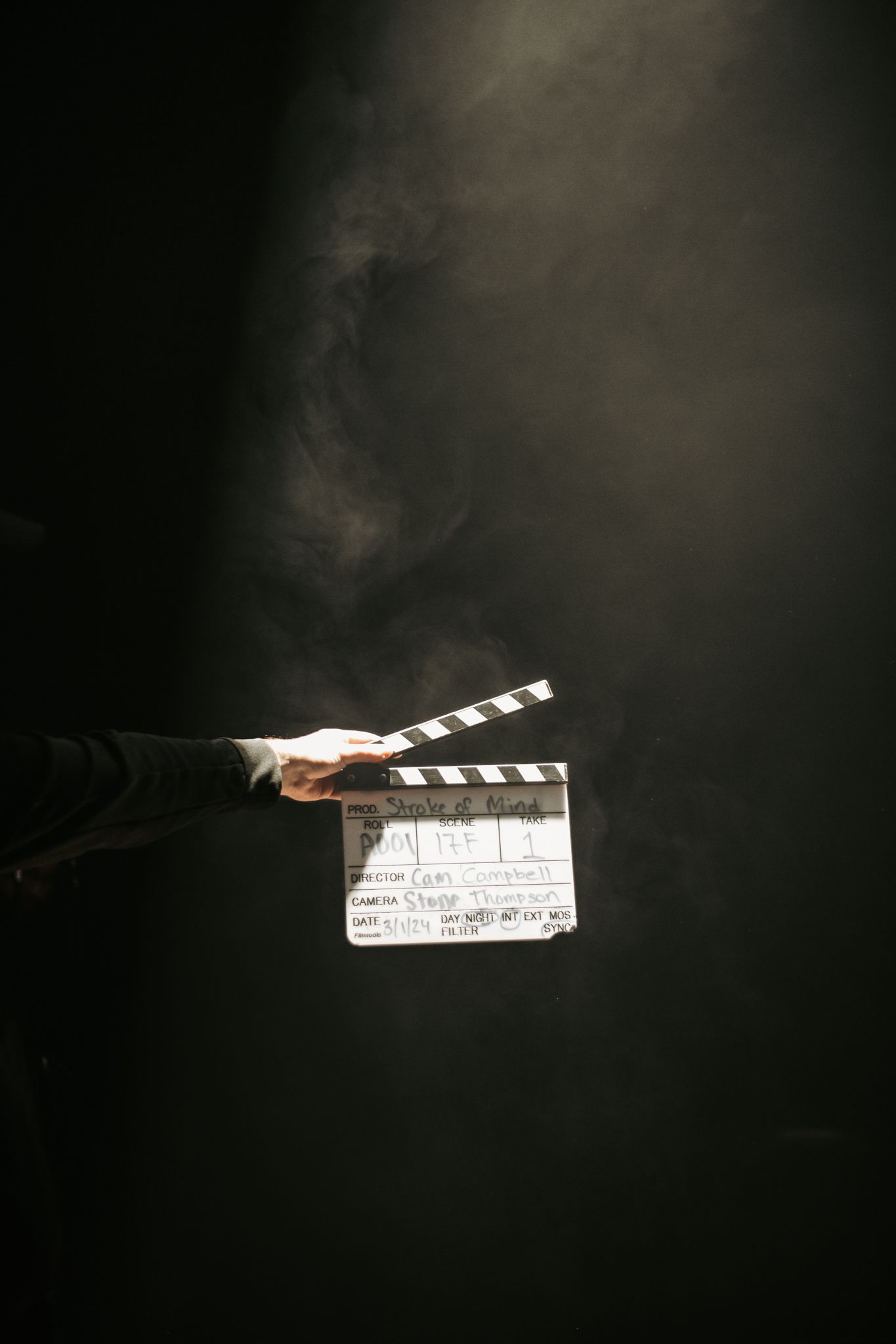 Film slate shrouded in dark foggy spotlight