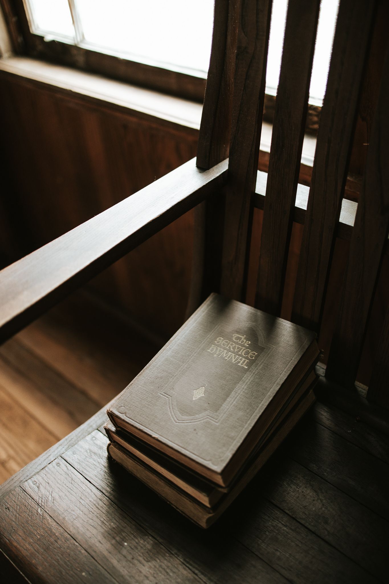 A hymnal on a prayer bench in an old chapel