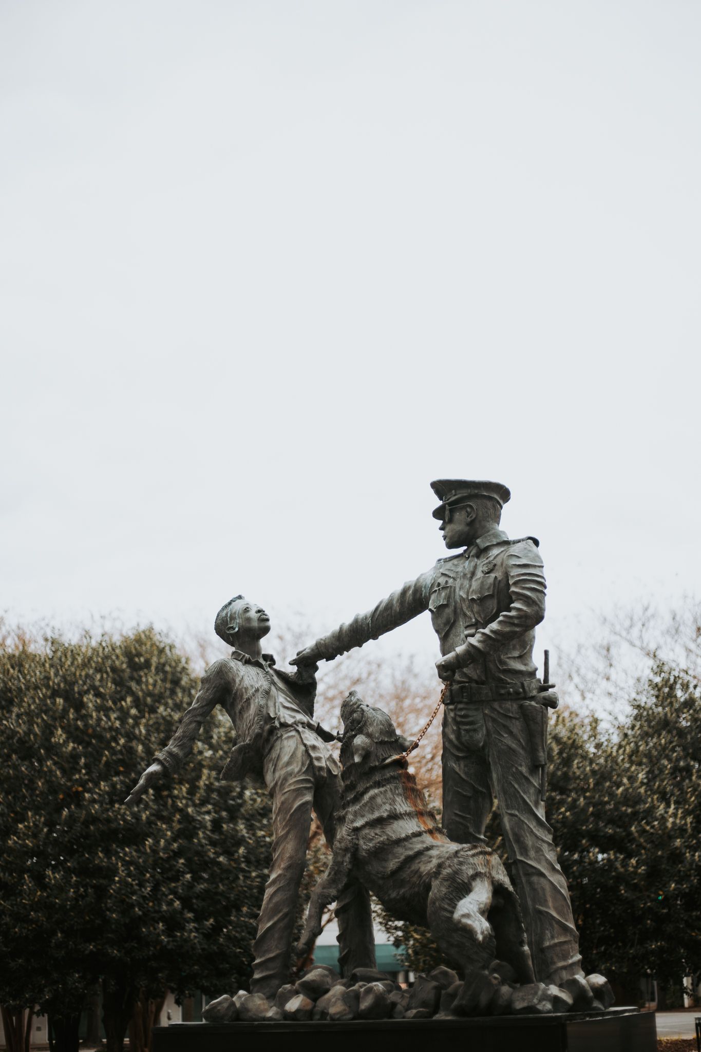 Statue in Birmingham Alabama of police officer holding a young boy's collar