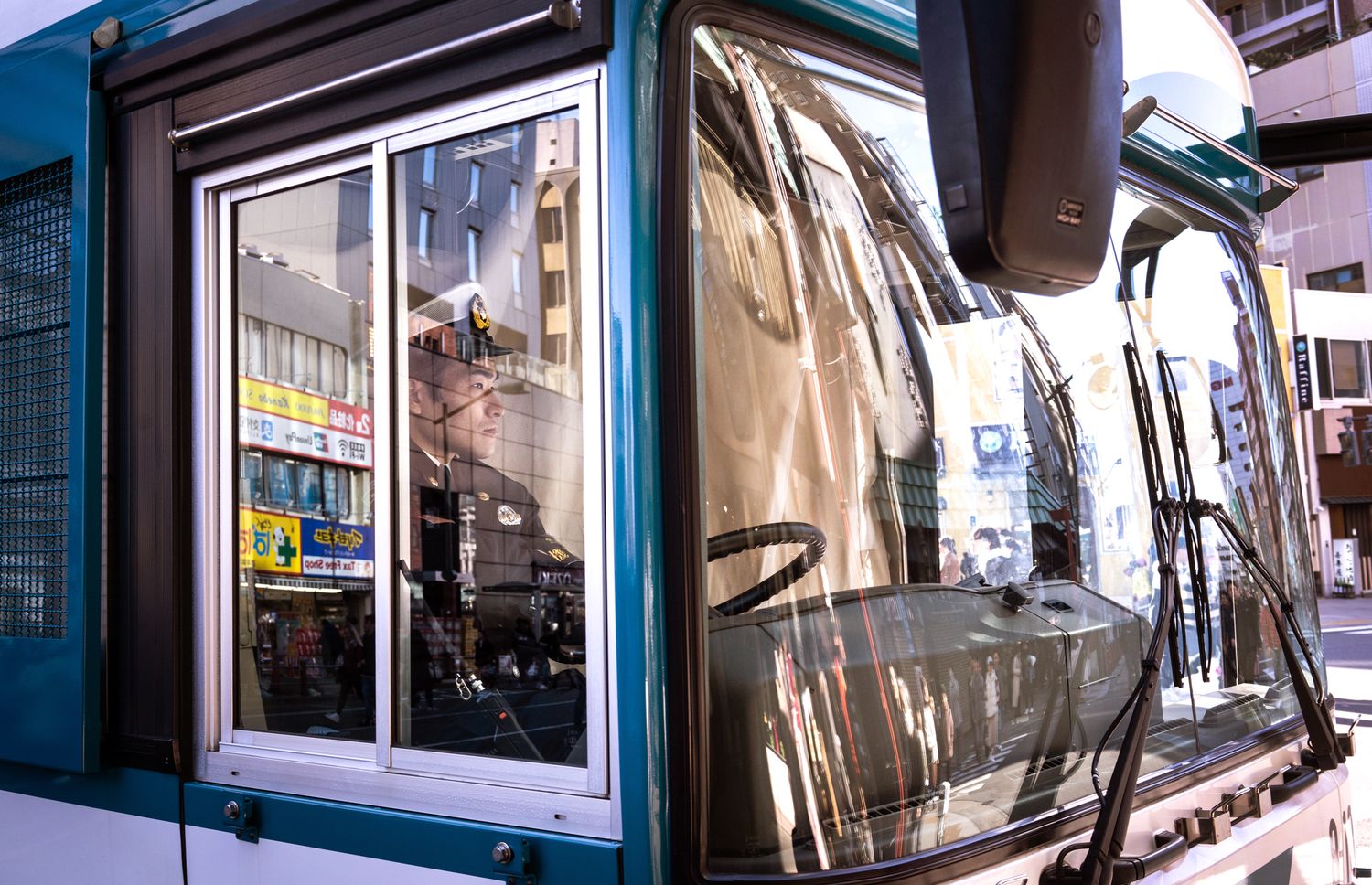 Modern storefront with reflective glass windows and metallic surfaces.