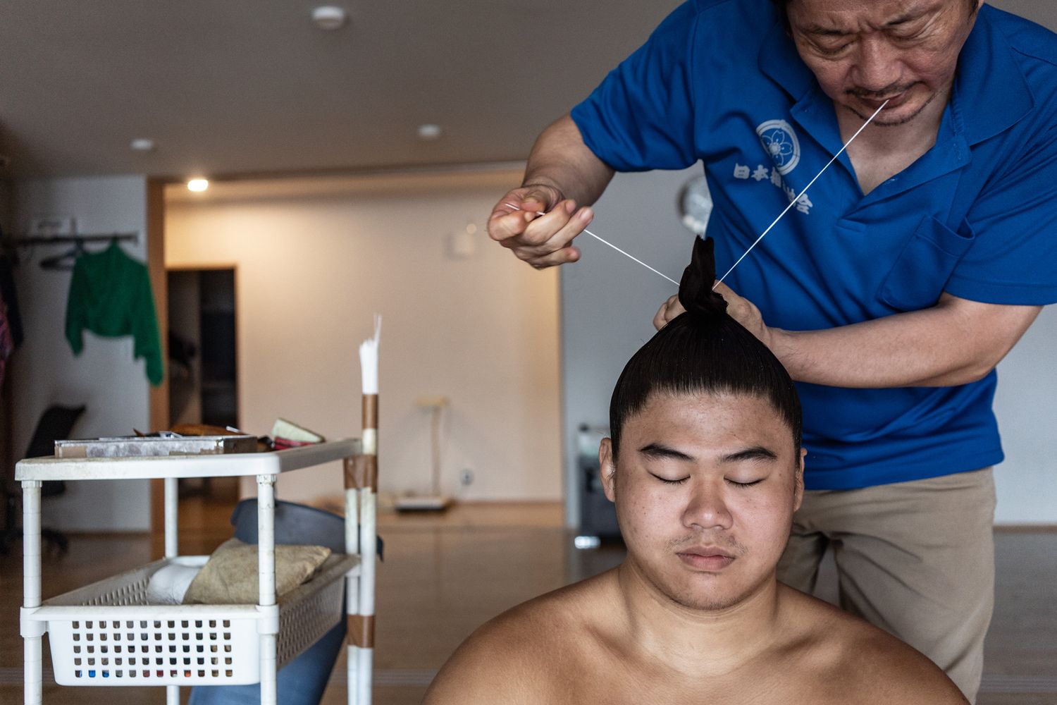 Professional stylist trimming hair in modern salon setting.