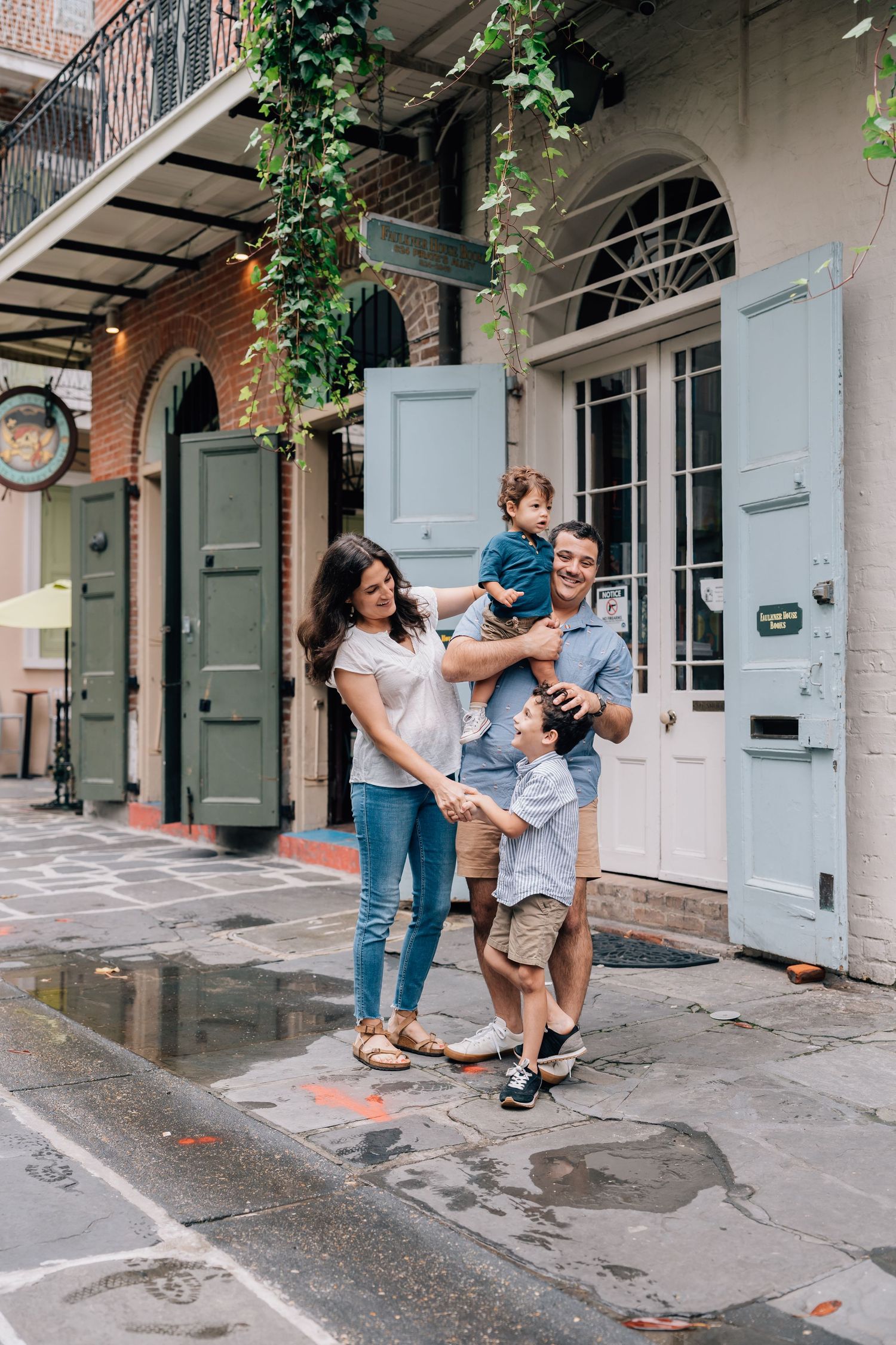 A family laughing together in Pirate's Alley, French Quarter