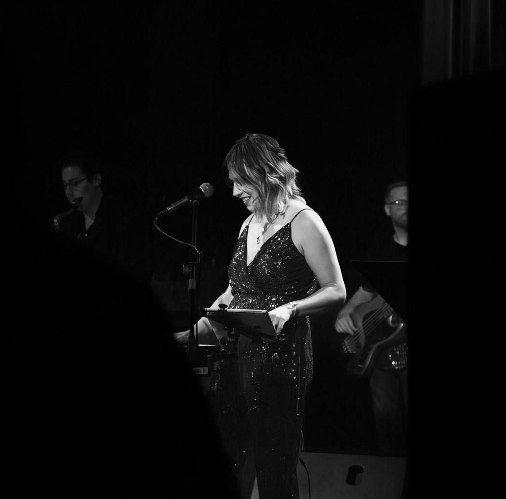 Singer smiling while on stage.