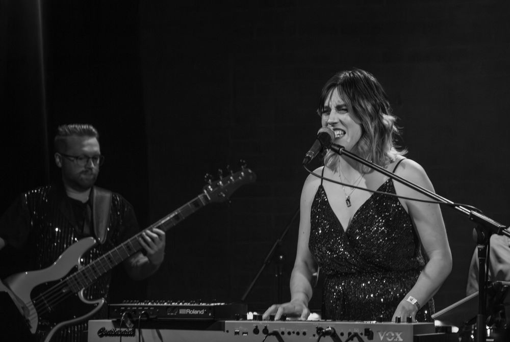 documentary style photograph of lead vocalist of a cover band.