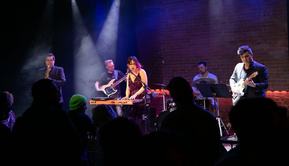 Jazz cover band playing music on stage.
