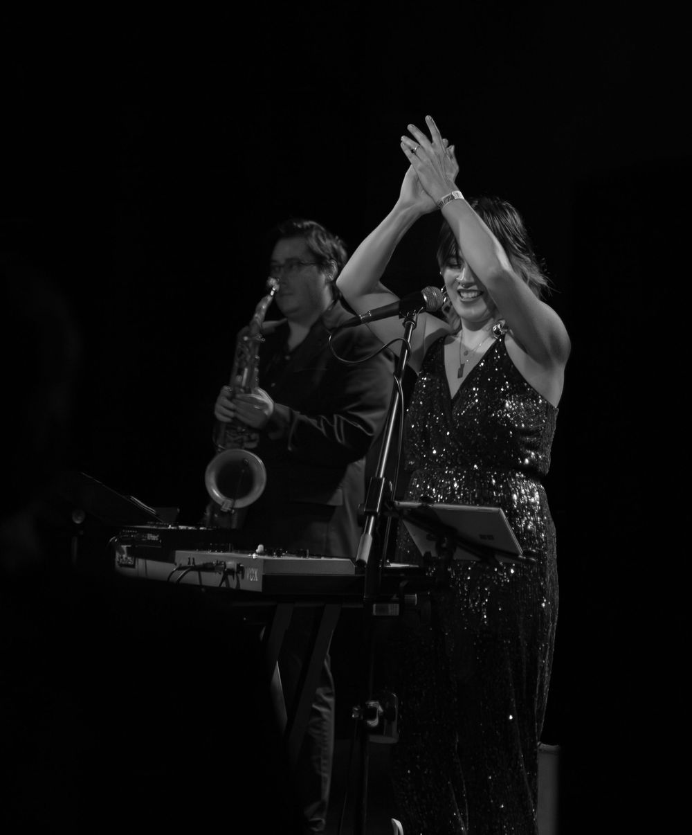 Lead vocalist clapping hands on stage.