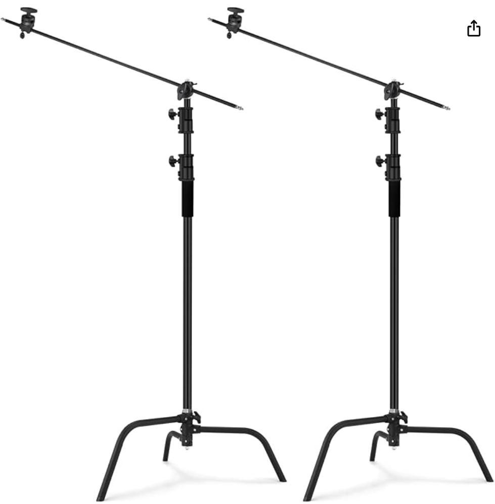 Two black C-stands with adjustable grip arms for photography and film lighting equipment setup.