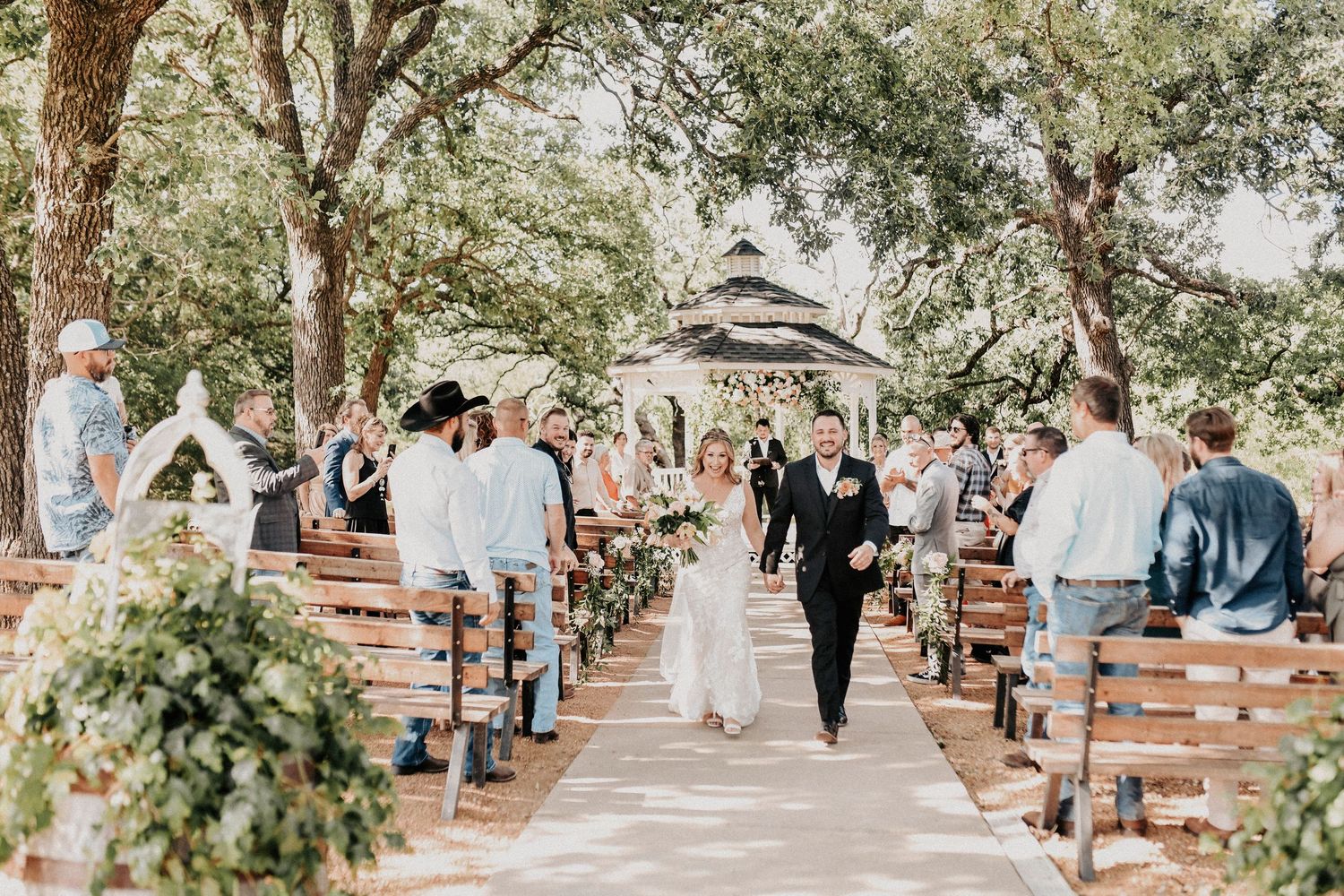 Editorial ceremony portrait of bride and groom standing together during their outdoor spring wedding.