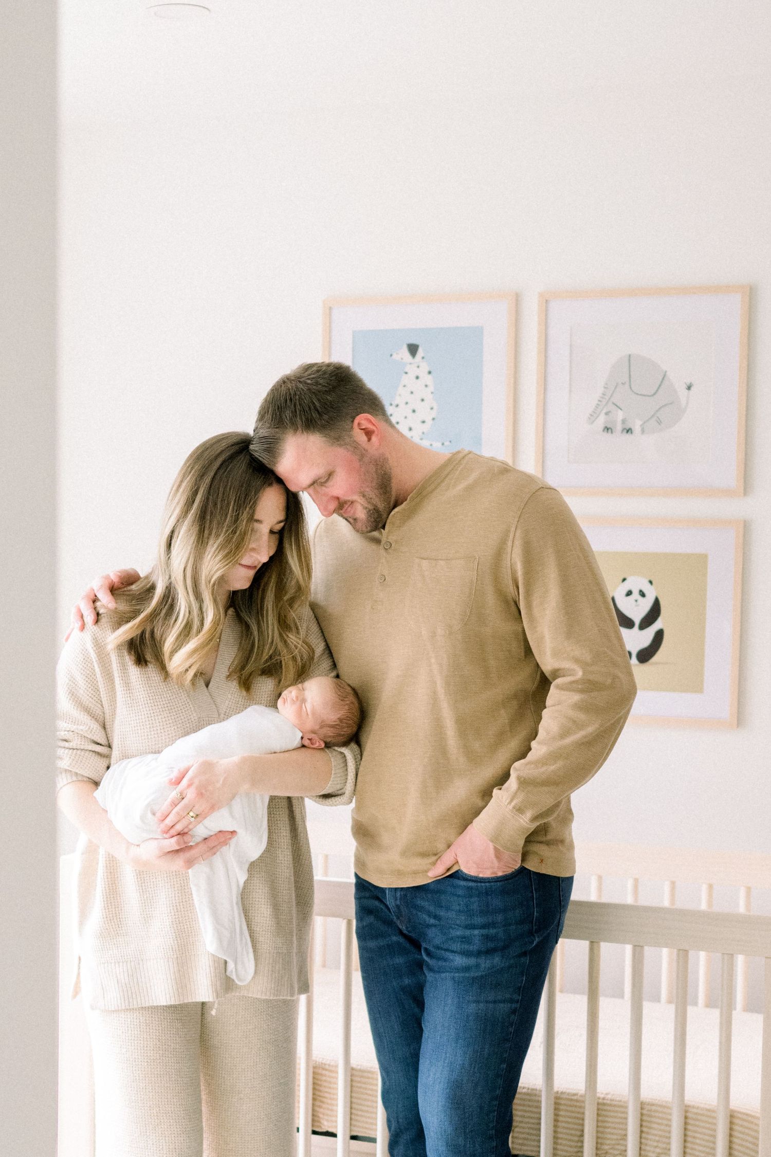 a new family in their nursery holding their baby in Falls Church, Virginia