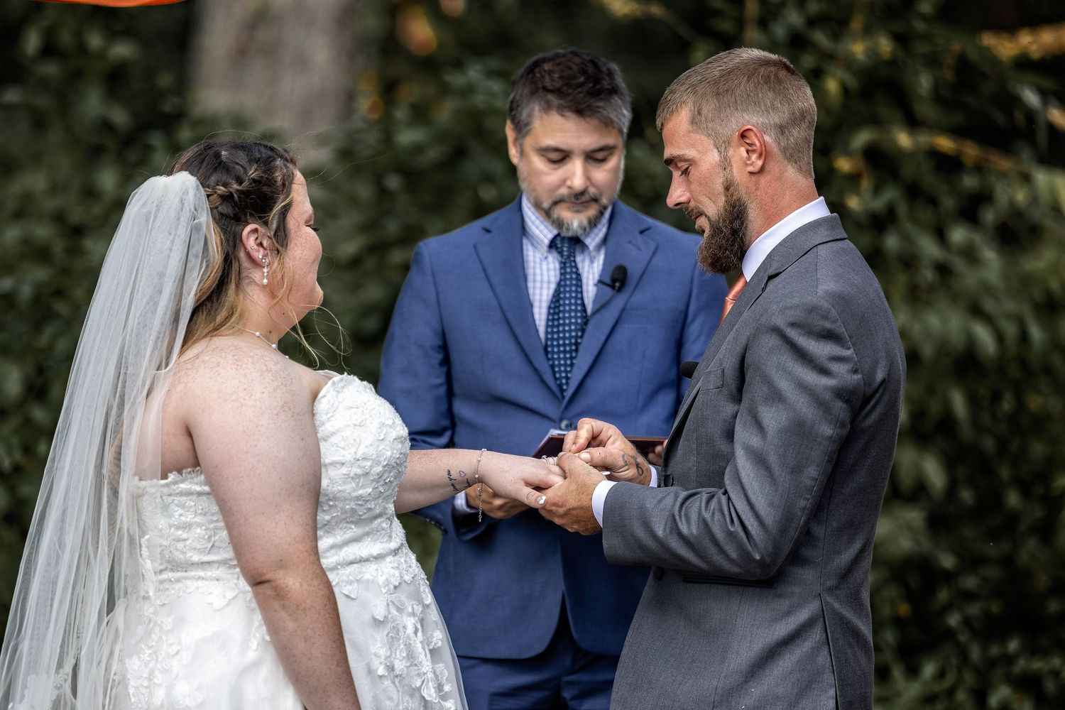 frederick maryland wedding photographer Wedding ceremony moments captured during ring exchange with autumn scenery.